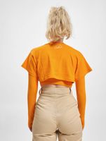 Le haut court Couture Club avec un imprimé gothique superposé en orange