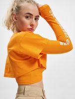 Le haut court Couture Club avec un imprimé gothique superposé en orange