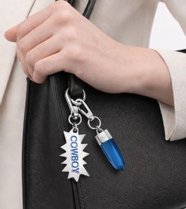 Modisches Calvin Klein Charm-Set Downtown Edelstahl-Anhänger mit kontrastfarbigen Harz und COWBOY-Schriftzug Taschen-Accessoires 7x1,3cm KJJCLA090300 Silber/Blau